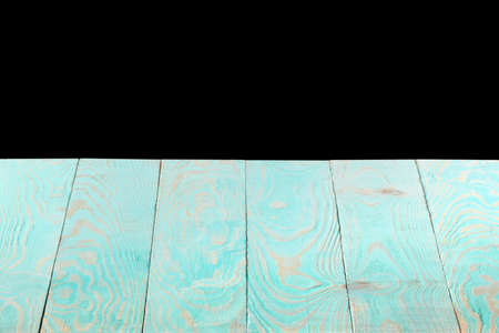 Blank blue wooden textured table on a black background.の写真素材