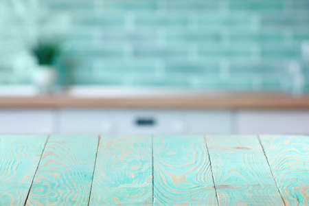 Wooden textured blue table on a background of blurred interior.の写真素材