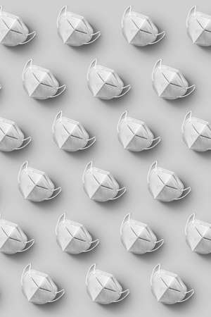 Vertical pattern with medical face masks on a grey background.の写真素材
