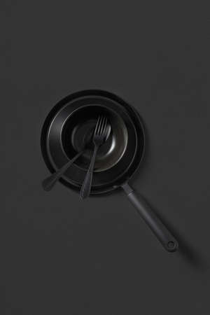 Set of different cooking empty utensil black colored on the same color background.の写真素材