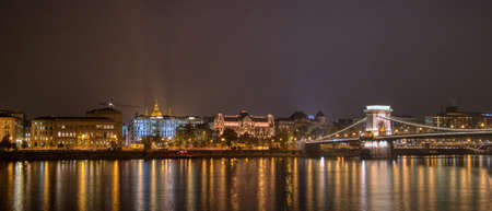 Night lighting view to the historical part and Chain bridge across the river in Budapest, Hungaryの写真素材
