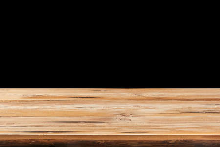 Retro wooden table on a black background can used for display or montage your products.の写真素材