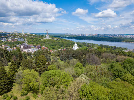 Botanical garden, statue, churches and cloudy skyの写真素材