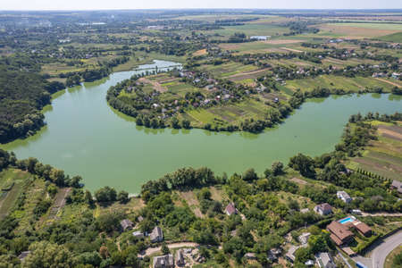 View from drone on village with green nature and riverの写真素材