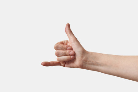 Female hand sign language Y sign on white.の写真素材