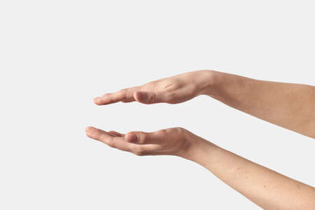 Open female hands on white soft grab action.の写真素材