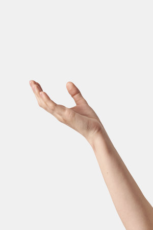 Close up raised female hand gesture on white.の写真素材