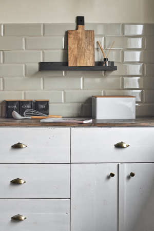 Kitchen white cabinets with kitchen utensils on the counter.の写真素材