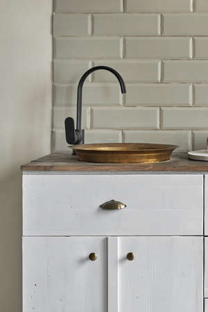 White cabinets with copper sink at kitchen counter residential house.の写真素材