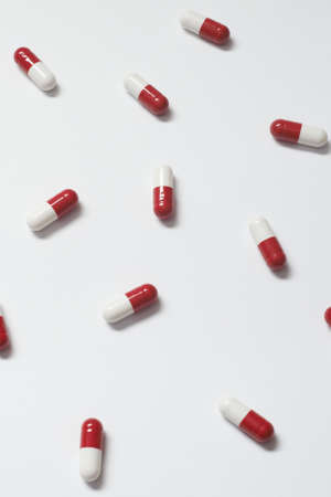 Pharmaceutical capsules over white backdrop.の写真素材