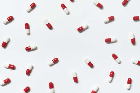 Pharmaceutical capsules over white backdrop.の写真素材