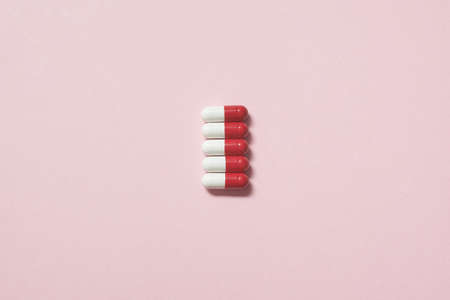 Pharmaceutical pills over pink backdrop.の写真素材
