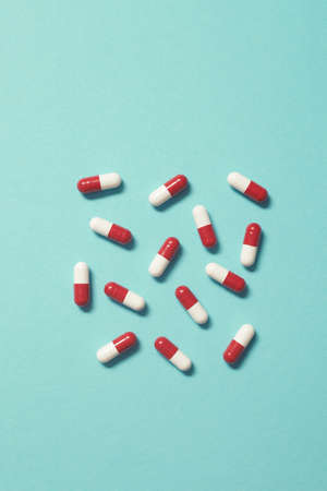Pharmaceutical pills over turquoise backdrop.の写真素材