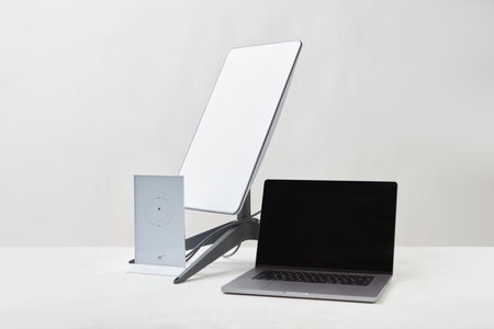 KYIV, UKRAINE - JANUARY 24, 2023: Starlink antenna, wi-fi router and laptop on white surface. Home office concept.のeditorial素材