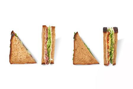 Cut club sandwich made with ham, avocado, cheese and iceberg lettuce isolatedの写真素材