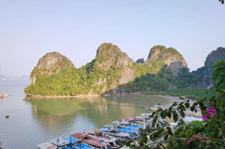 Picturesque view of UNESCO Ha Long bay. Tourist boats are moored to the shore.のeditorial素材