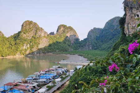 Picturesque view of UNESCO Ha Long bay. Tourist boats are moored to the shore.のeditorial素材