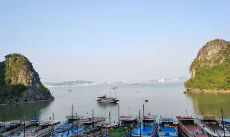 Picturesque view of UNESCO Ha Long bay. Tourist boats are moored to the shore.のeditorial素材