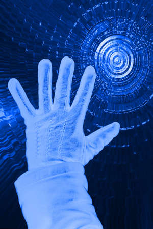 Hand in glove on dark blue abstract background.の写真素材
