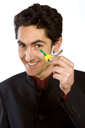 Portrait of handsome  man with keys. Isolated on white background.の写真素材