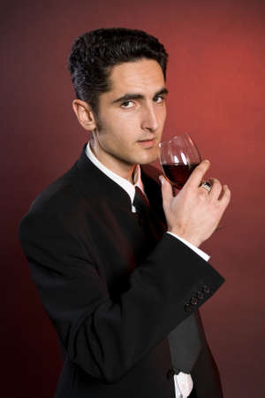 Portrait of glamour man with bocal of red wine.の写真素材