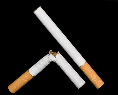 Two cigarettes isolated on black background.の写真素材