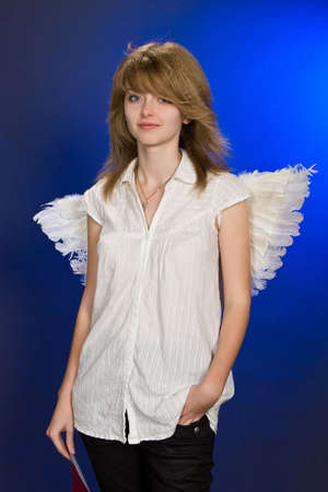 Portrait of beautiful girl with red heart and wings.の写真素材