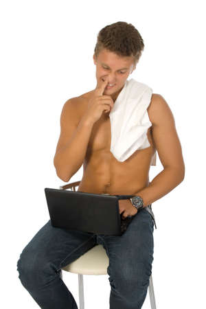 Successful young man is working on laptop. Humour. Isolated on white background.の写真素材