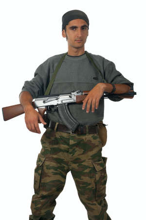 Man in camouflage with gun. Isolated on white background.の写真素材