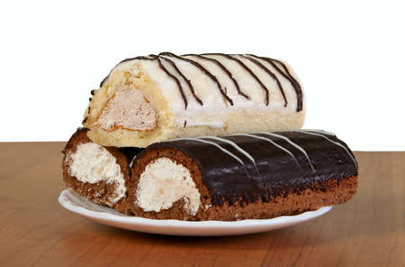 Three small appetizing cakes on white saucerの写真素材