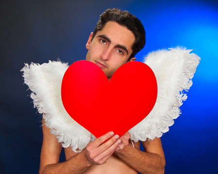 Portrait of glamour man with white wings and heart.の写真素材