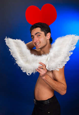 Portrait of glamour man with white wings and heart