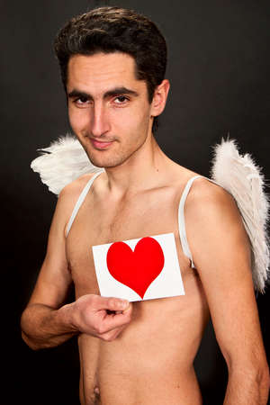 Portrait of glamour man with white wings and heartの写真素材