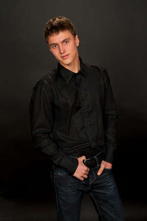 Portrait of young man on dark background.の写真素材