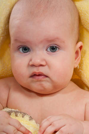 Portrait of a newborn girl in a yellow plaidの写真素材