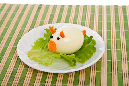 Carving from lettuce and eggs in form pigletの写真素材