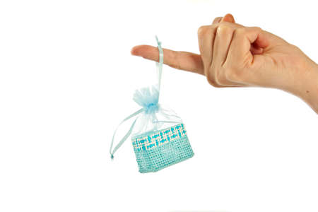 Blue straw paper-bag on finger. Isolated on white background.の写真素材