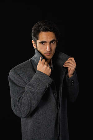 Portrait of handsome man on black background.