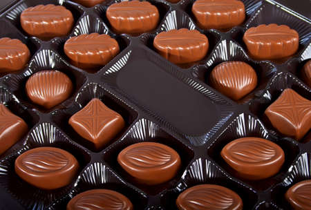 Milk chocolate candies in dark box の写真素材