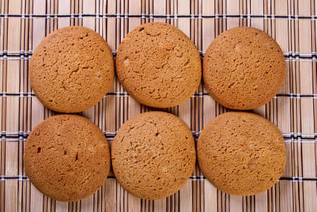 Clouse-up of oatmeal cookie on straw napkin.の写真素材