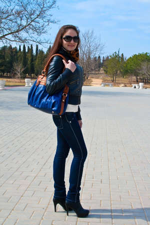 Portrait of young woman with handbag の写真素材
