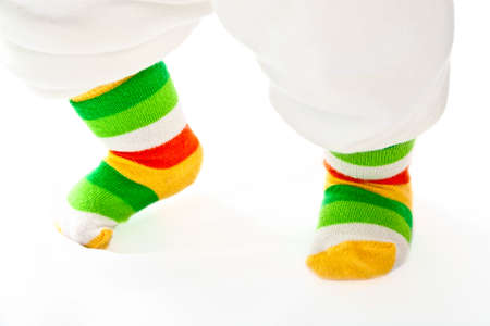 Small baby legs in sport striped socks.の写真素材
