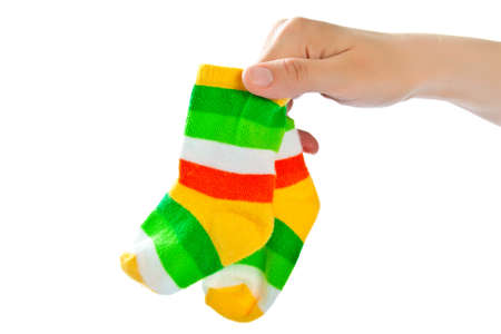 Two striped sport baby socks in woman's hand.の写真素材