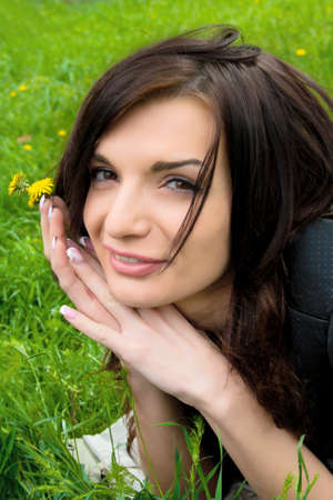 Portrait of young sexy woman on the park with flower の写真素材