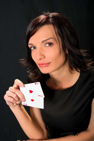Young lucky gambler with cards in hand 