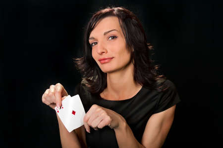 Young lucky gambler with cards in hand 