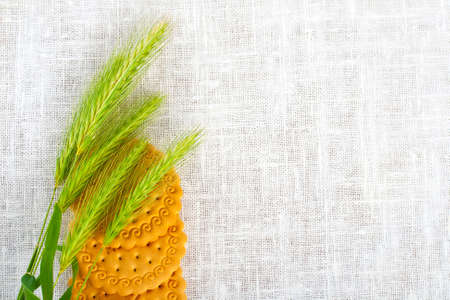 Green ears with pastry on white napkin.