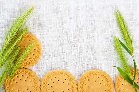 Green ears with pastry on white napkin.