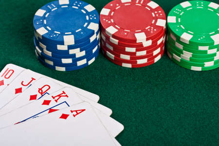 Chips and cards for the poker on the table の写真素材