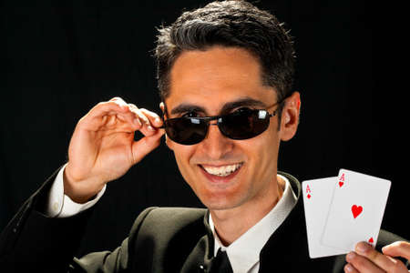 Young lucky gambler with cards in hand の写真素材